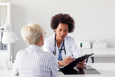 accident-injury-doctor-looks-over-patient-file